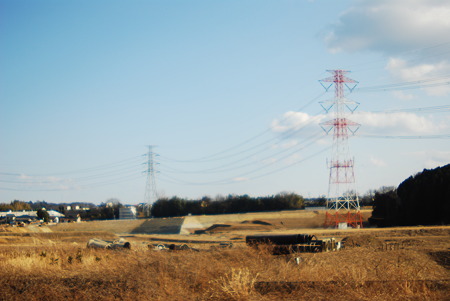 High-voltage electrical power lines passing through the reclaimed land.